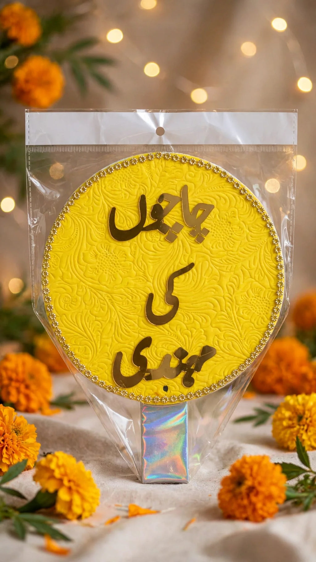 Yellow velvet mehndi hand prop with Chachu Ki Mehndi in gold letters and gold bead border