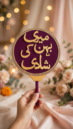 Premium purple velvet hand prop with Meri Behen Ki Shaadi in gold glitter letters