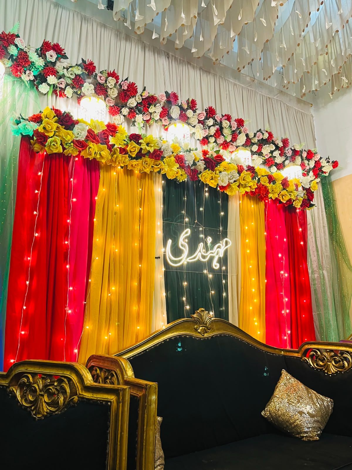 Mehndi night decoration Karachi with neon sign floral topper and fairy light curtains – image 1