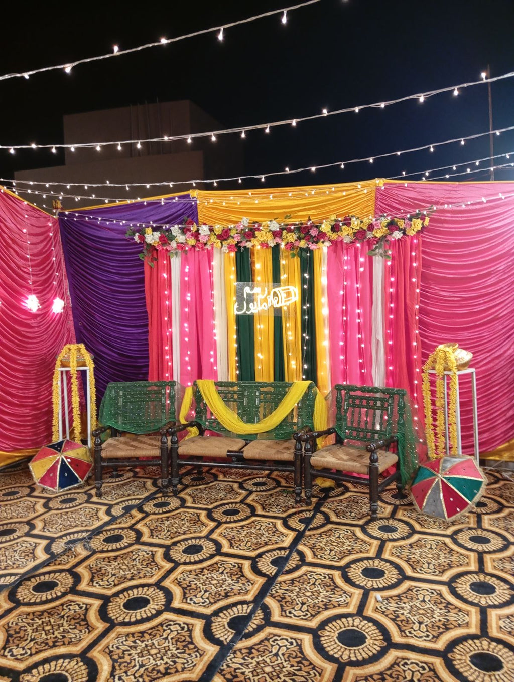 Rooftop dholki decoration Karachi with colourful curtain backdrop and fairy light canopy – image 2