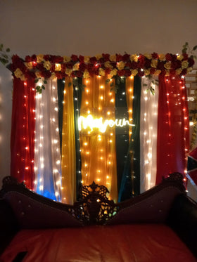 Mayun decoration Karachi with neon sign fairy light walls and colourful curtain backdrop – image 1