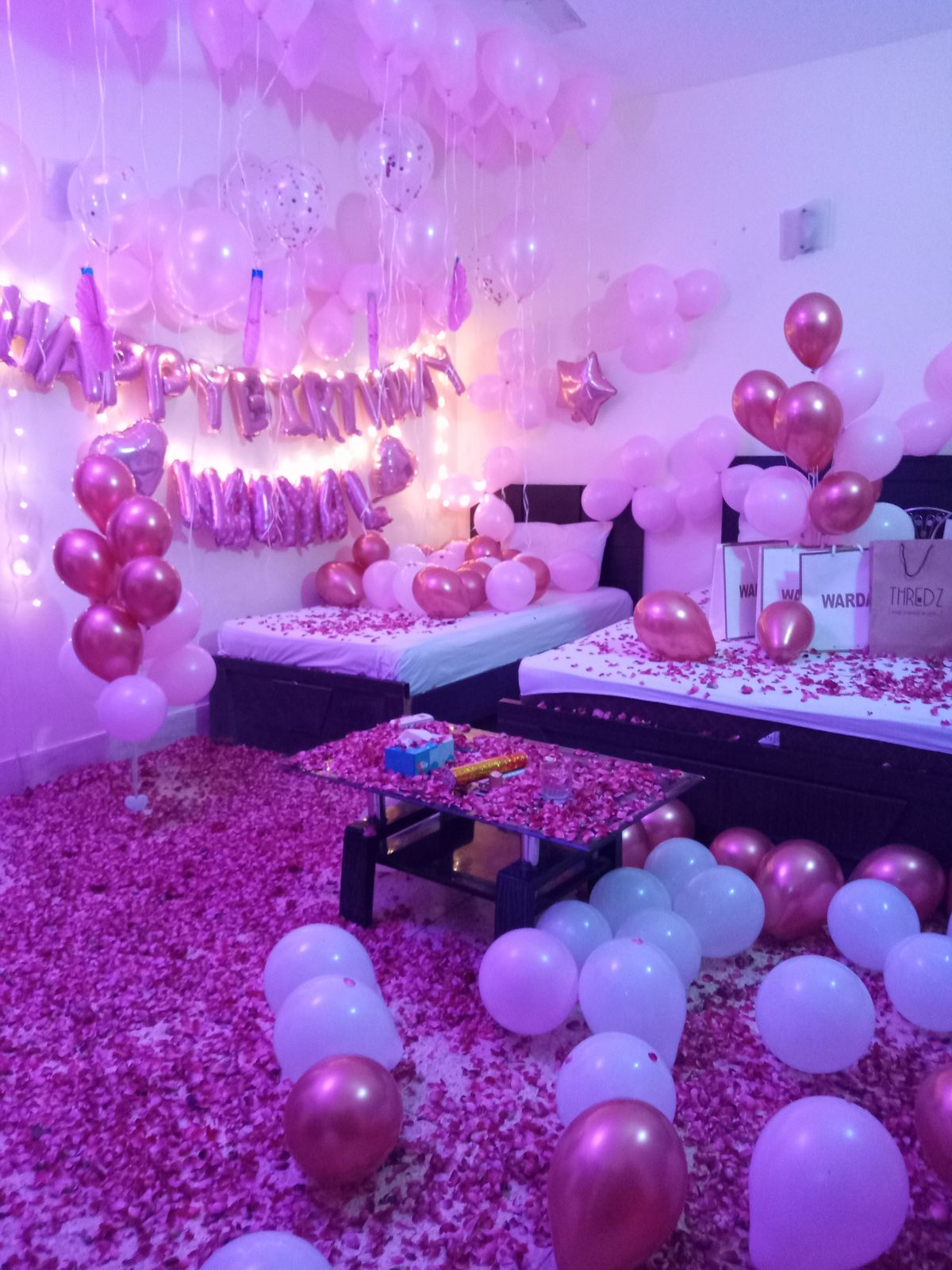 Pink and rose gold surprise birthday anniversary room decoration Karachi with balloons and rose petals – image 4