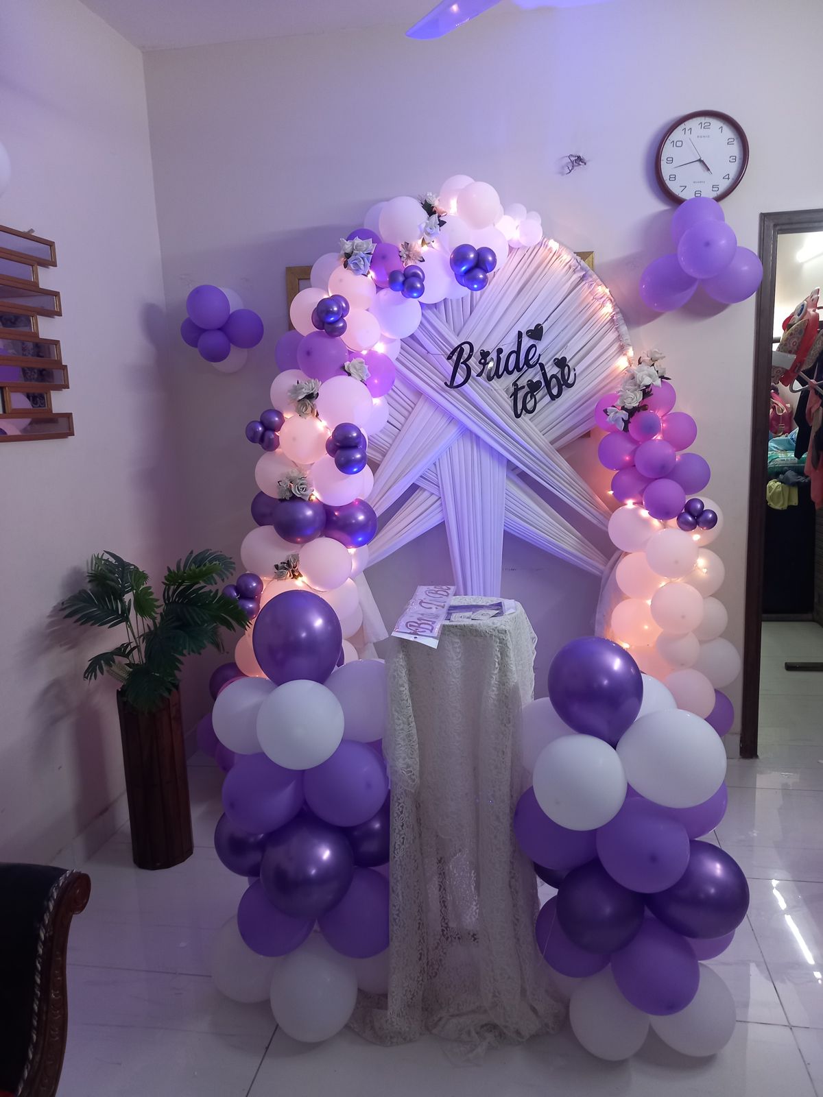 Purple and white bridal shower decor Karachi with bride to be arch, fairy lights and balloon pillars – image 1