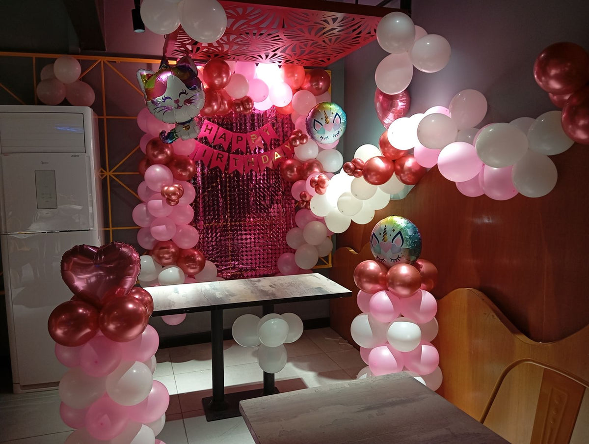 Restaurant Birthday Decor – Pink & White Balloon Pillars with Fringe Curtain Backdrop