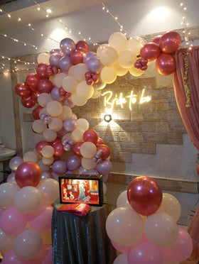 Rooftop bridal shower decoration Karachi with bride to be neon sign, pink balloon garland and fairy lights – image 1