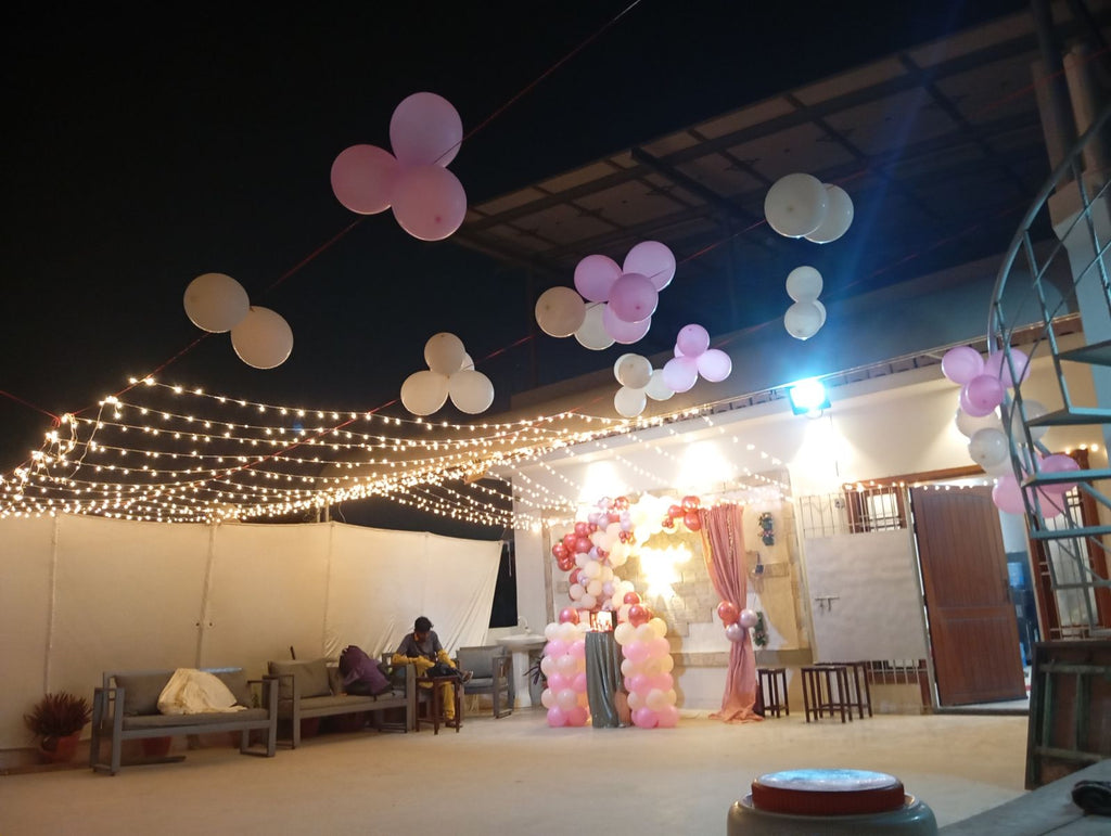Rooftop bridal shower decoration Karachi with bride to be neon sign, pink balloon garland and fairy lights – image 10