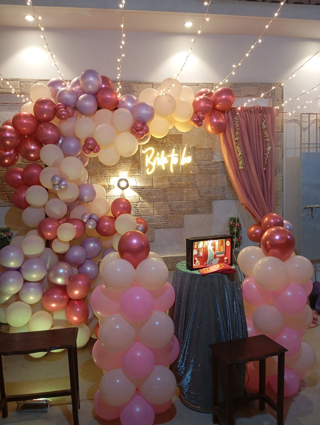 Rooftop bridal shower decoration Karachi with bride to be neon sign, pink balloon garland and fairy lights – image 2