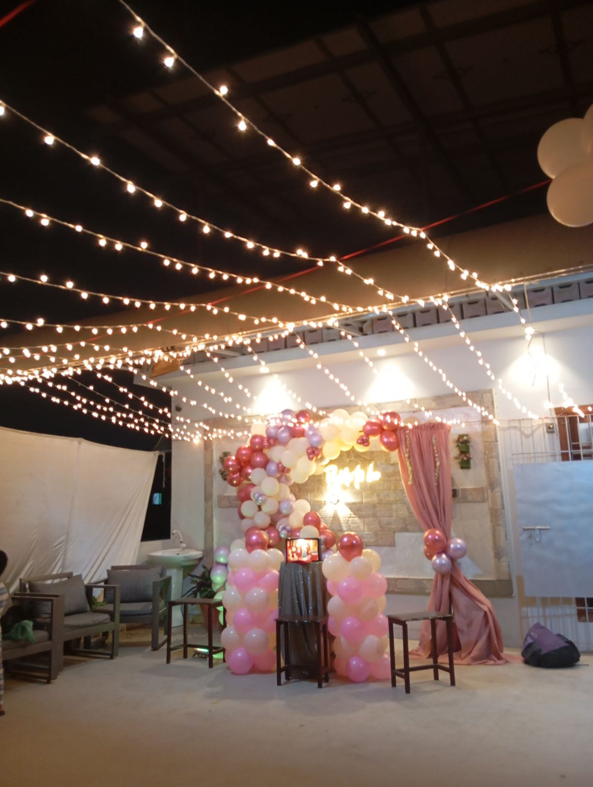 Rooftop bridal shower decoration Karachi with bride to be neon sign, pink balloon garland and fairy lights – image 6
